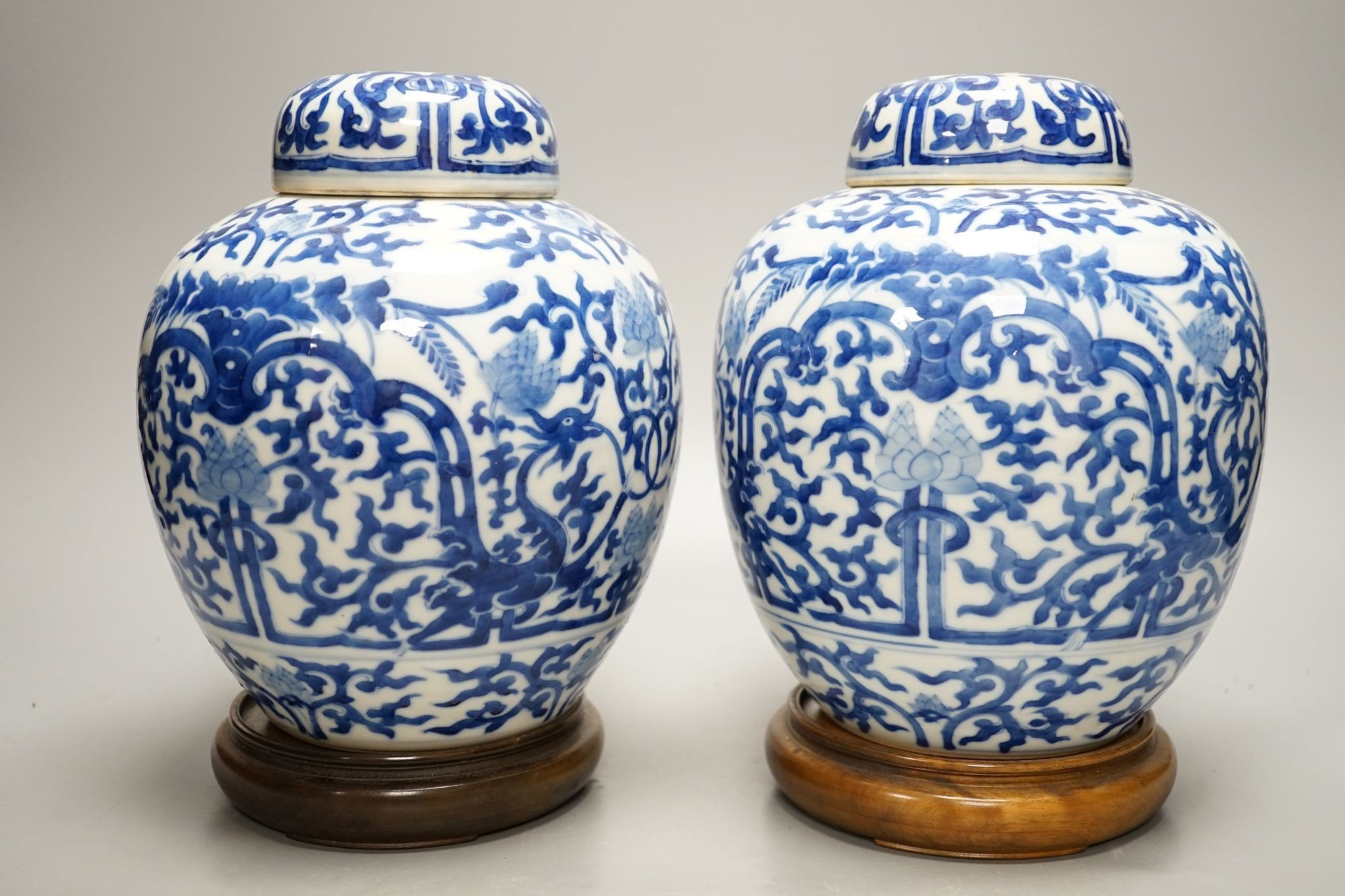 A pair of Chinese blue and white ginger jars and covers, 22cm, On stands